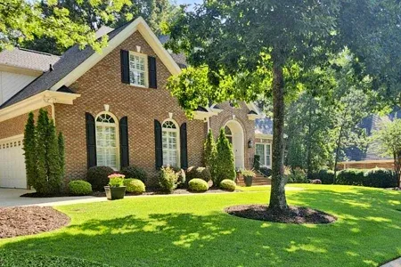 brick home with nice lawn