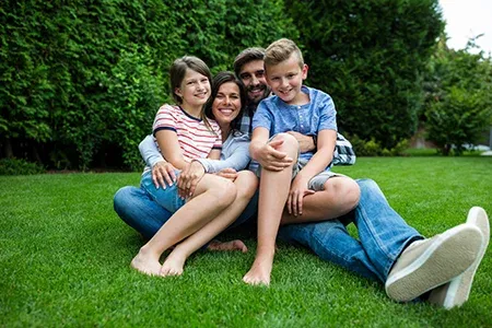 family sitting in grass