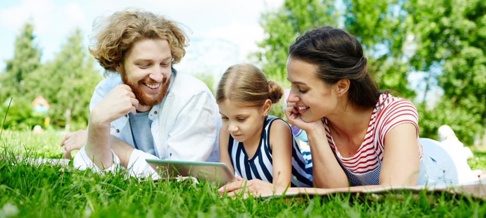 family reading on their lawn